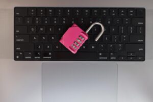 closeup pink combination lock computer keyboard representing internet security online safety open lock creative idea weak protection security internet data leak 338491 28282