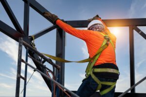 construction workers wear safety equipment prevent falls from heights fall arrestor device worker with hooks safety body harness construction site 61243 1614 1