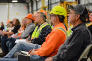 group construction workers wearing hard hats safety vests are standing row looking something 1162225 55449