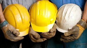 group sturdy construction helmets held by workers uniform building site generative ai 934909 24043