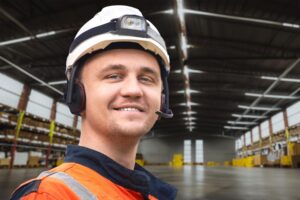 large storage facility with shelves boxes person safety gear is working warehouse 782515 12299