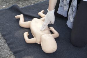 midsection paramedics performing cpr baby mannequin 1610319 905 1