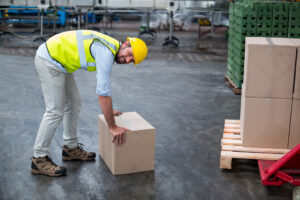 portrait factory worker picking up cardboard boxes 107420 76077