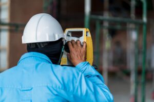 rear view construction worker surveying construction site 9693 5482 1