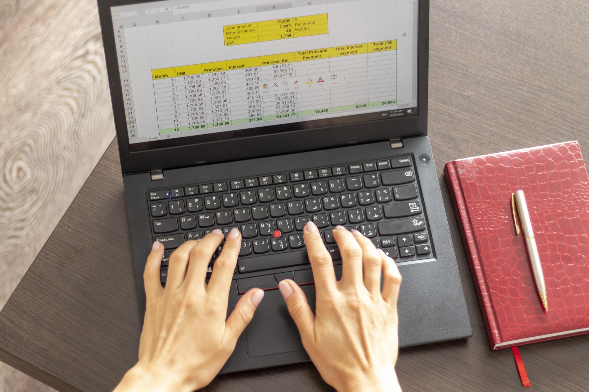 Home 15 shot woman working laptop showing excel sheet screen with bank loan amortization table finance 594692 239