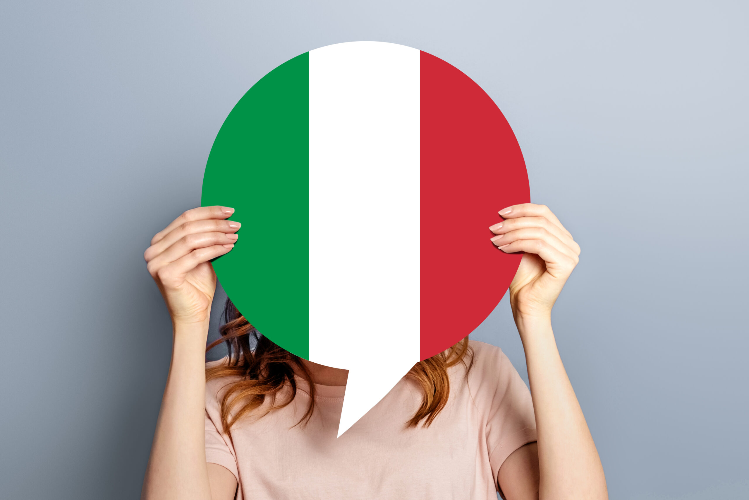 Home 12 student girl holds blank white speech bubble with italian flag isolated grey studio background woman holding round information piece paper dialog scaled