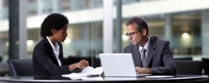 two people are looking laptop one them is wearing glasses 970765 20978