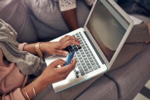 woman credit card laptop couch ecommerce online shopping buying from store website home family computer finance payment banking internet financial freedom 590464 414213